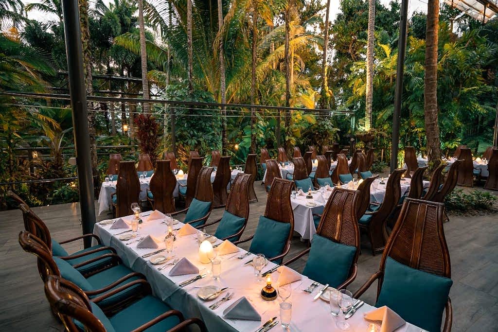 Tables set for event under palm trees at Nautilus